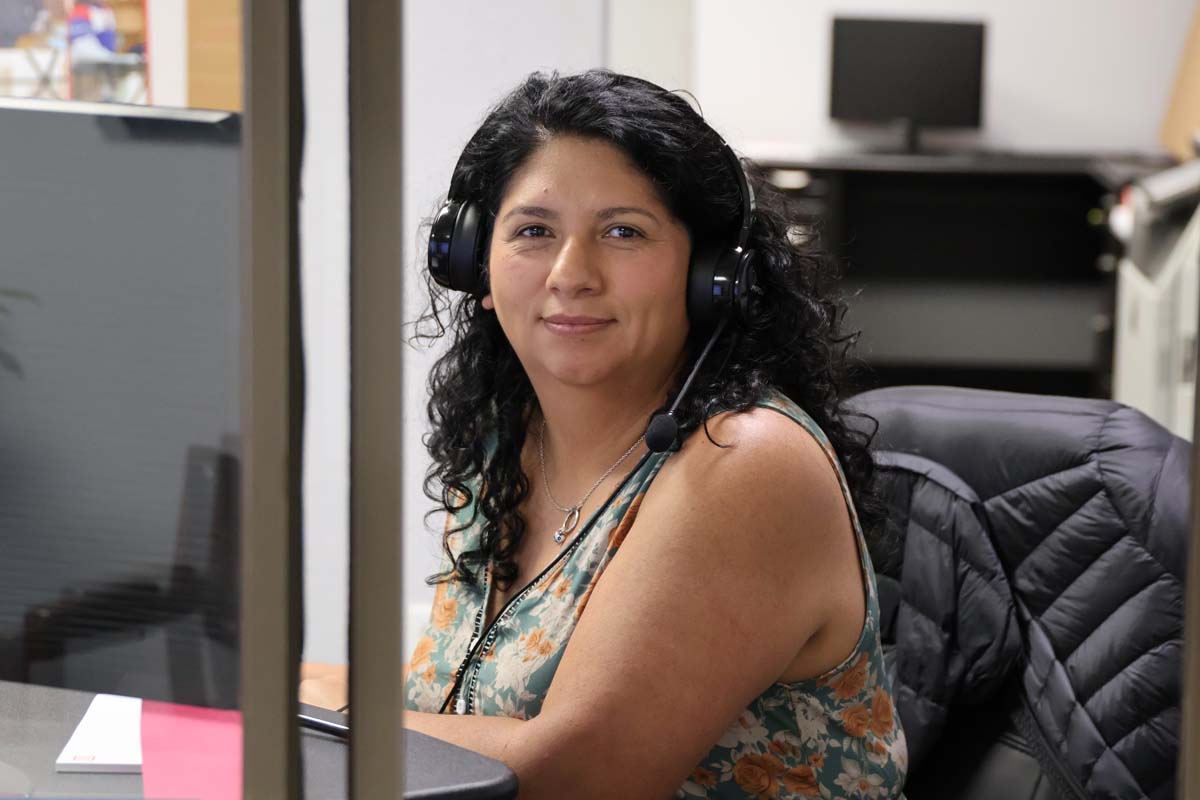 Worker Wearing Headset At Desk - Leaman Container, Inc.